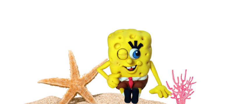 A yellow SpongeBob SquarePants character winks and sits on sand next to a starfish and pink coral against a black background, perfect as a fondant cake topper.