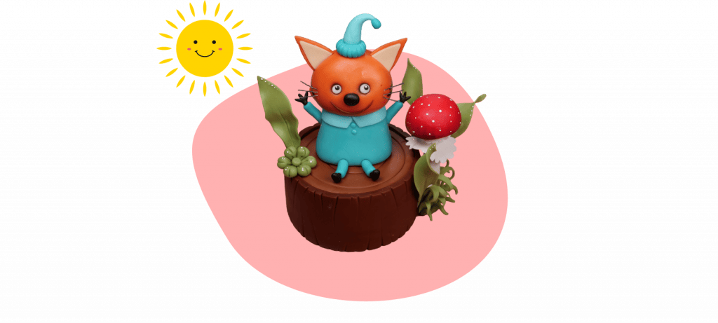 Colorful clay fox figure with a blue outfit and hat sits on a stump next to a mushroom under a smiling cartoon sun on a pink background, perfect as a fondant cake topper inspired by Kid-e-Cats.