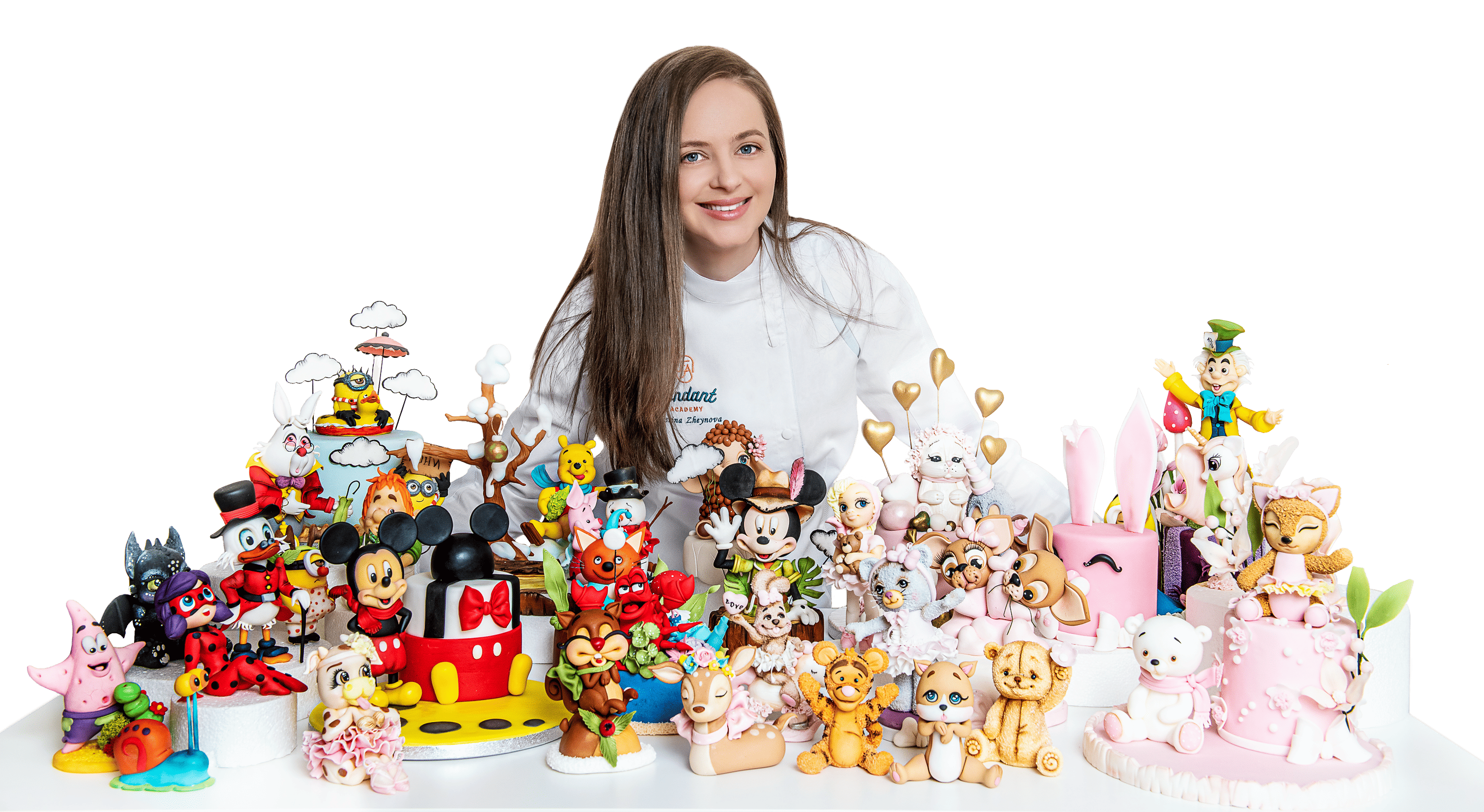 A woman stands behind a table filled with various colorful cartoon and animal-themed cakes, each adorned with charming cake toppers and figurines.