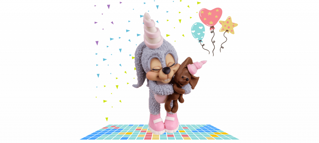 A cute cartoon dog in a unicorn costume hugging a small stuffed dog, with colorful balloons and confetti in the background—a perfect fondant cake topper idea.