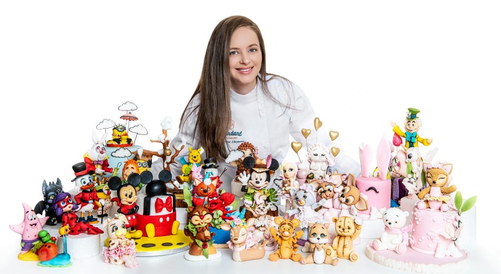 A person surrounded by various colorful cartoon character figurines and sculptures on a white background, highlighting the diverse range available at unbeatable pricing.