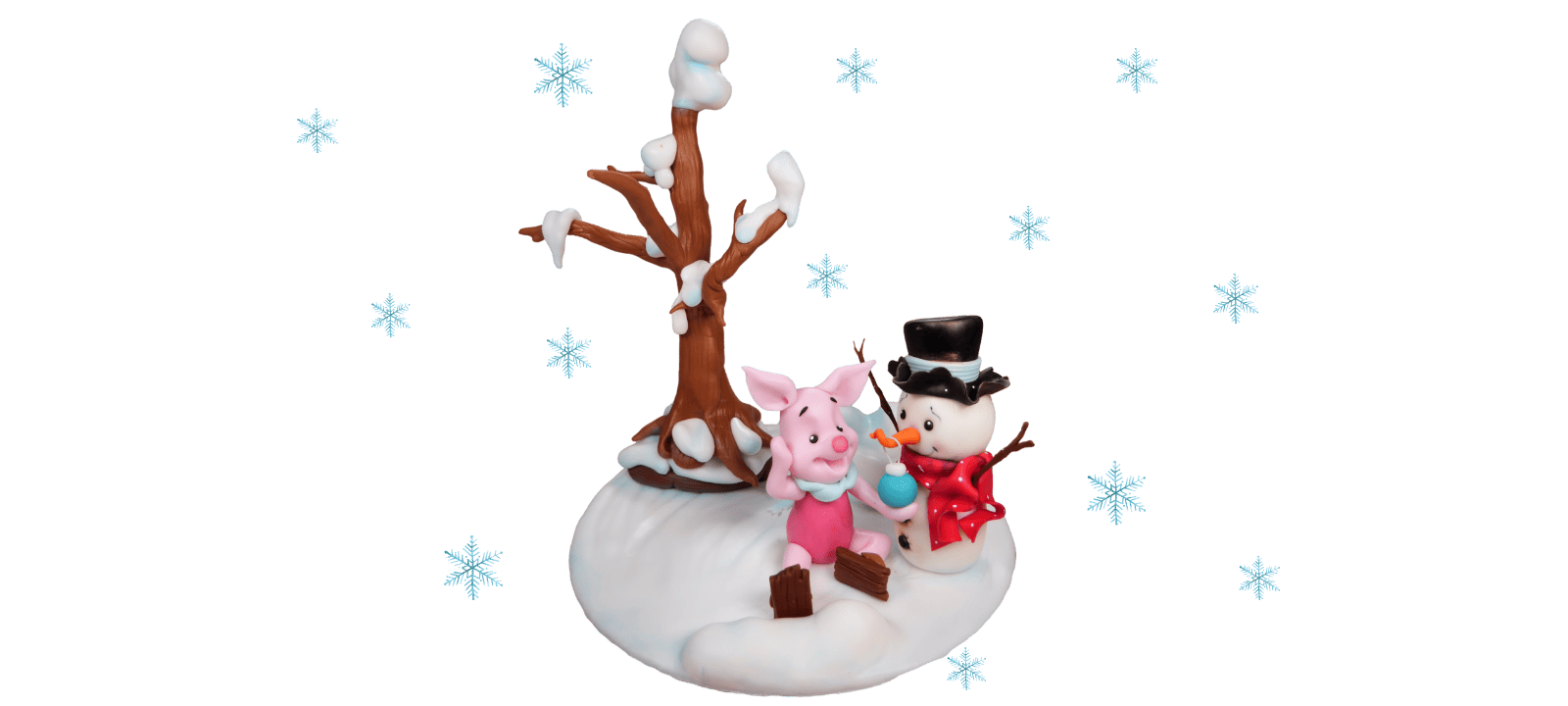 Figurine of a piglet in the snow and a snowman in winter attire sitting on a snowy base with a tree in the background, surrounded by snowflakes. Perfect as a fondant cake topper or for crafting enthusiasts following a video tutorial.