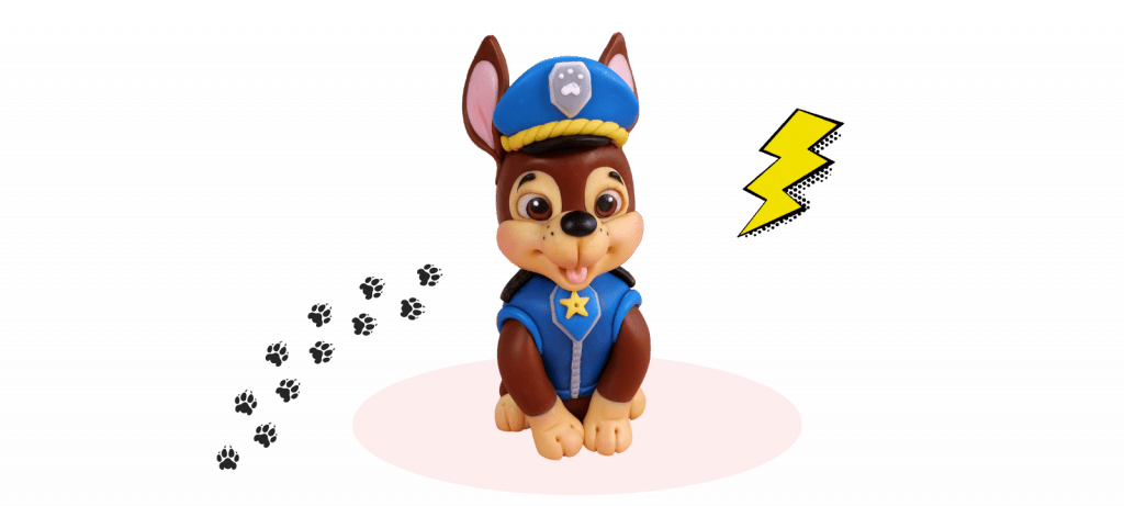 A fondant cake topper features a cartoon dog in a police uniform sitting on a white oval with paw prints behind and a yellow lightning bolt to the right, perfect for any PAW Patrol fan.