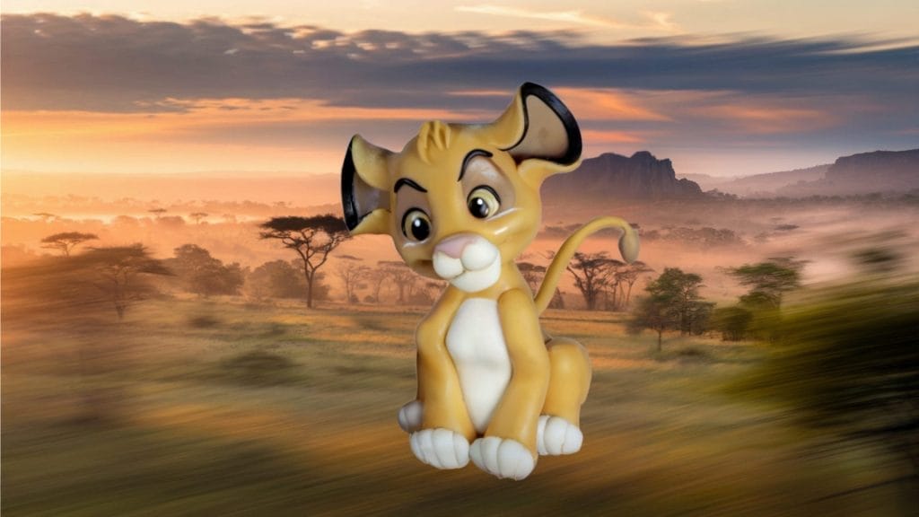 Simba sits against a blurred savannah sunset, perfect as a Simba fondant cake topper.